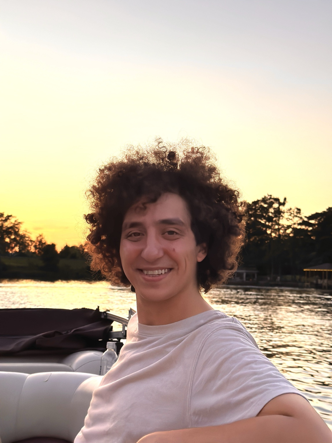 Korash Assani beside a lake at sunset